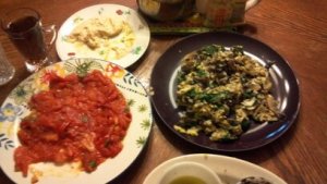 Breakfast of eggs with portabello mushrooms and spinach; tomatoes sauteed with garlic and serrano pepper, hummus, olive oil & zataar, and tea.